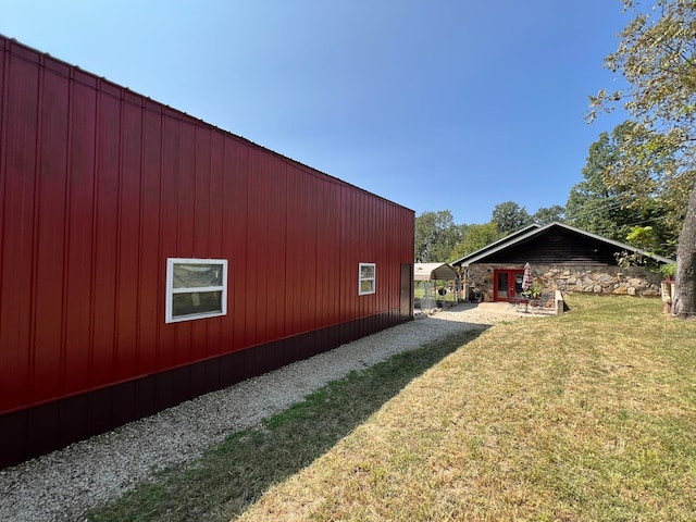 view of side of home with a yard