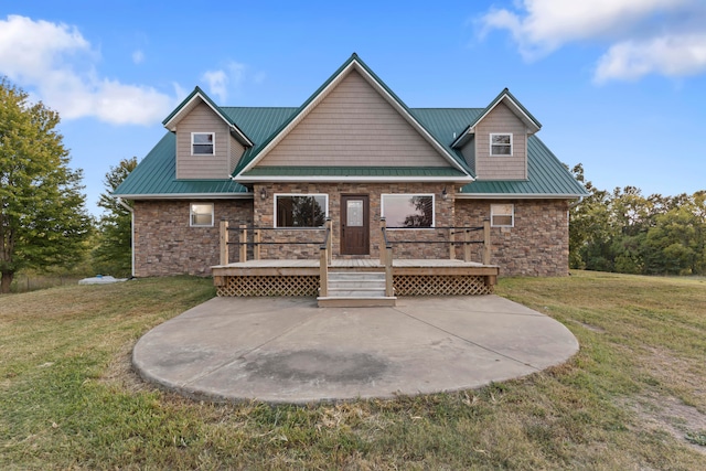 view of front of home with a front yard and a wooden deck