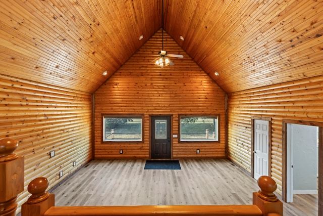 additional living space featuring high vaulted ceiling, wooden ceiling, rustic walls, and light hardwood / wood-style flooring