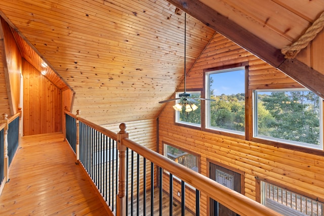 hall with log walls, light hardwood / wood-style floors, high vaulted ceiling, and wooden ceiling