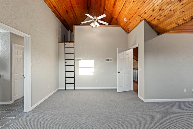 carpeted spare room with ceiling fan, vaulted ceiling, and wood ceiling