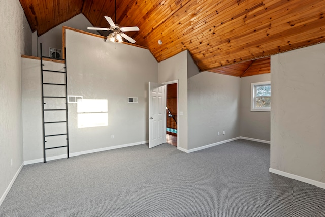 carpeted spare room featuring lofted ceiling, wood ceiling, and ceiling fan