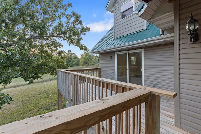 wooden terrace with a yard