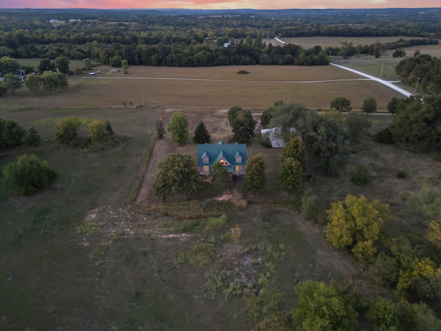 aerial view at dusk featuring a rural view