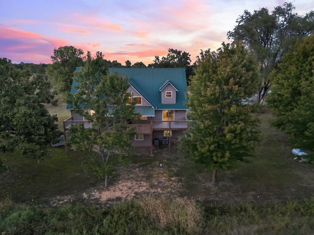 view of back house at dusk