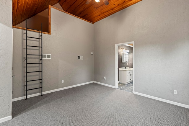 interior space featuring high vaulted ceiling, ceiling fan, wood ceiling, sink, and carpet floors