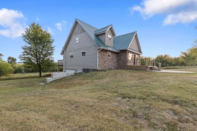 view of side of property featuring a wooden deck and a yard