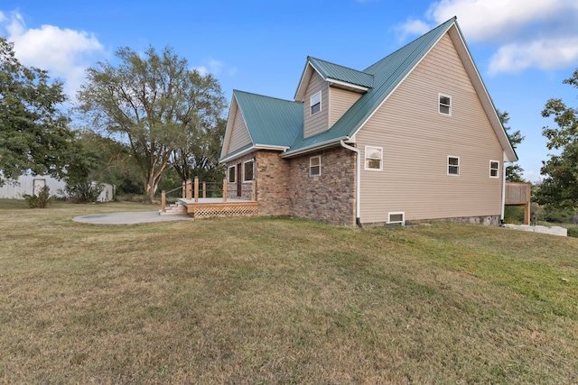 view of side of property featuring a yard and a deck