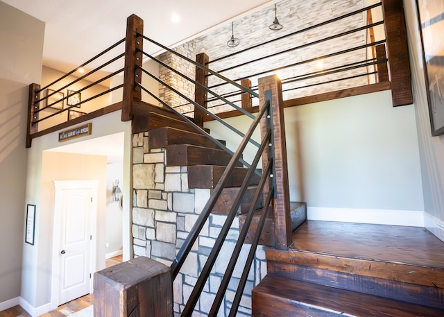 stairs featuring wood-type flooring