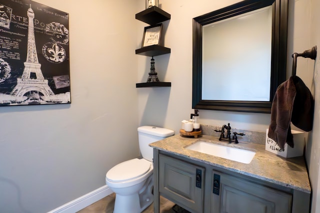 bathroom featuring toilet and vanity