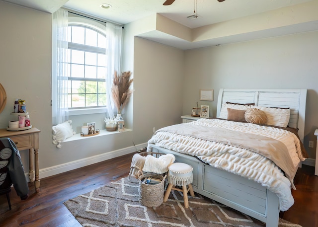 bedroom with ceiling fan and dark wood-type flooring