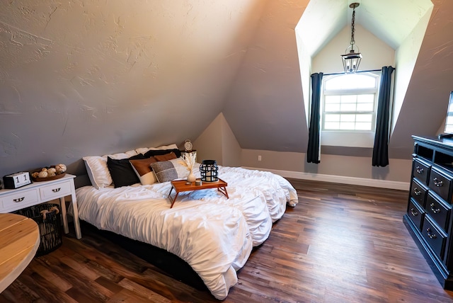 bedroom featuring lofted ceiling and dark wood-type flooring