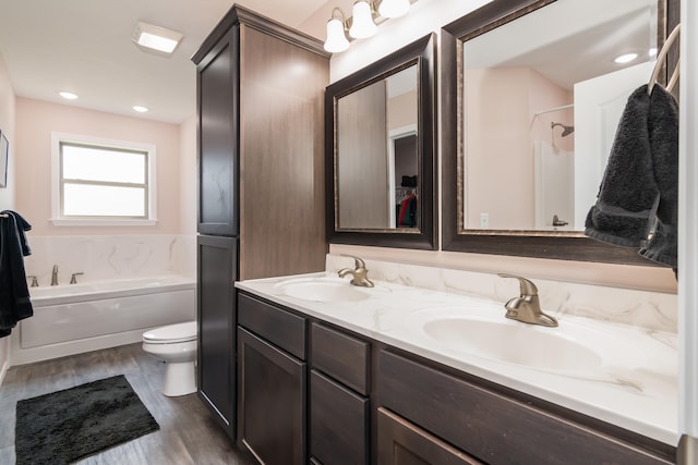 full bathroom featuring toilet, plus walk in shower, vanity, and wood-type flooring