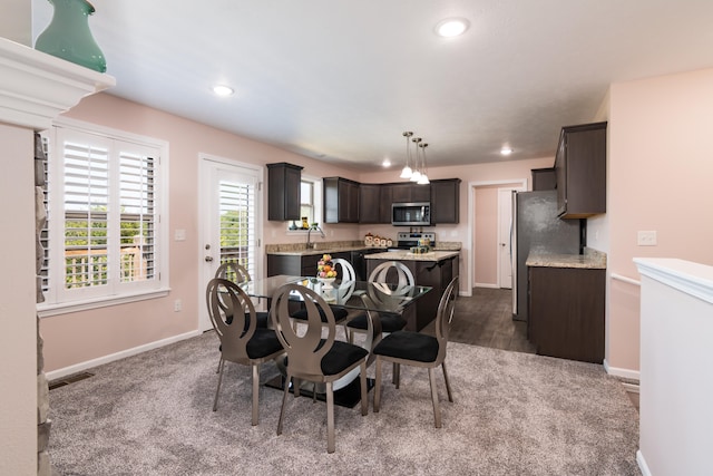 dining room featuring dark colored carpet