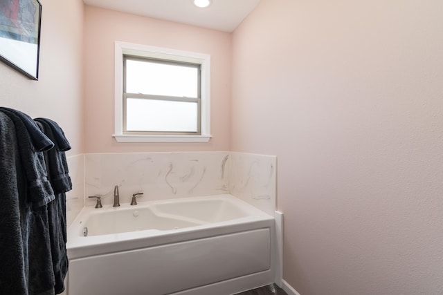 bathroom featuring a tub to relax in