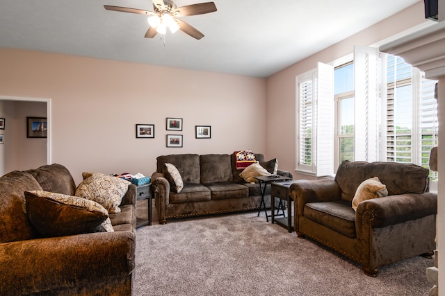 living room featuring carpet and ceiling fan