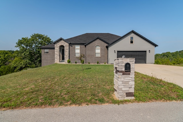 view of front of property featuring a front yard and a garage