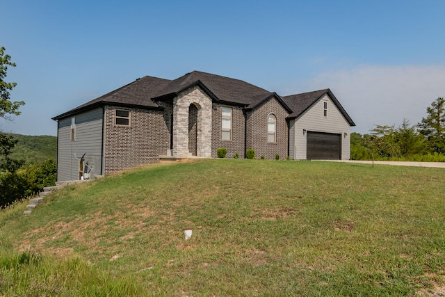 view of front of property with a garage and a front lawn