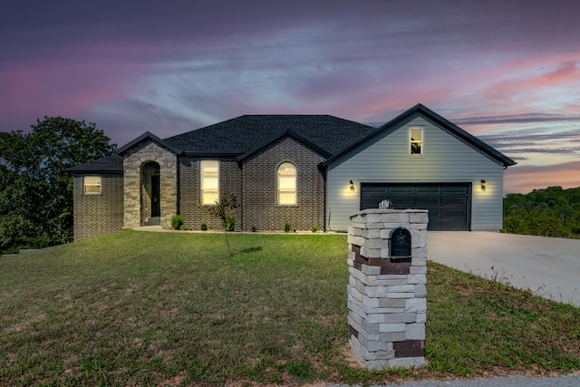 view of front of home featuring a lawn and a garage