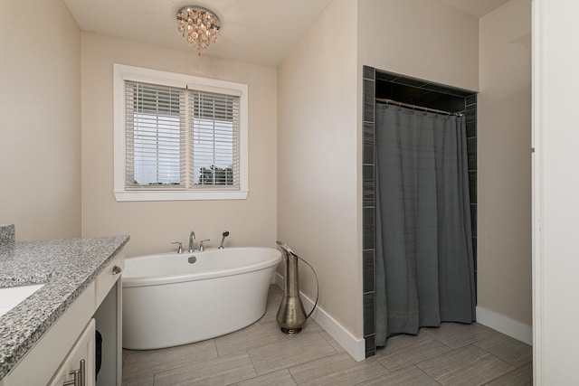 bathroom with a washtub and vanity