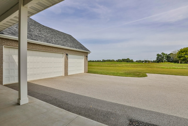 garage featuring a lawn