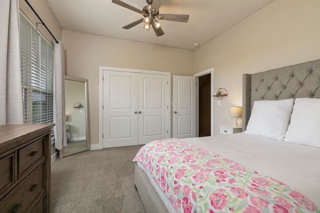 carpeted bedroom featuring ceiling fan and a closet