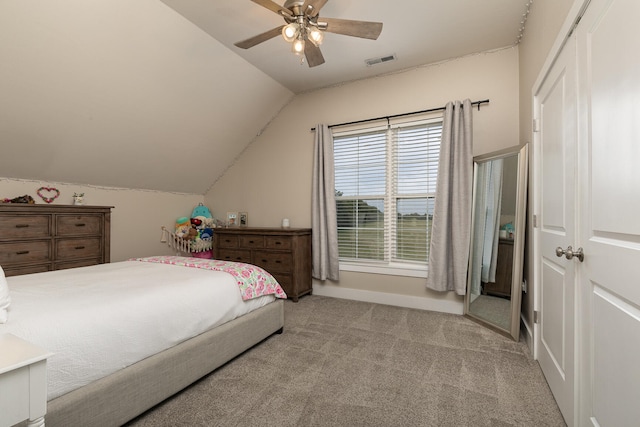 bedroom with lofted ceiling, ceiling fan, and light carpet