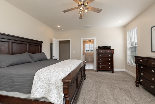 carpeted bedroom with ceiling fan and ensuite bath