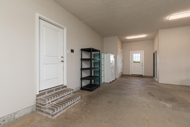 garage with white fridge with ice dispenser