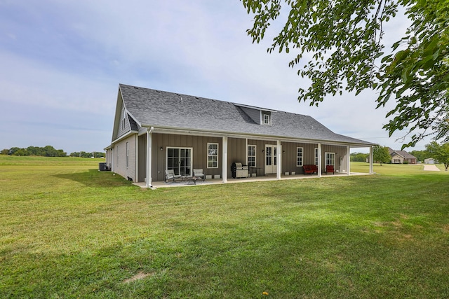 back of house with a lawn and a patio