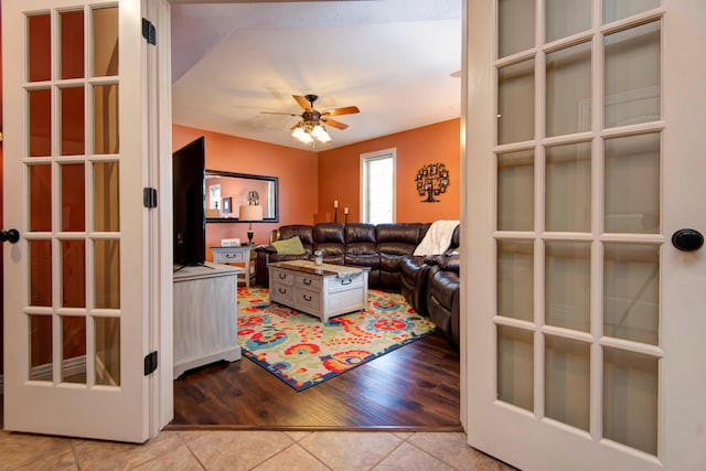 living room featuring light wood-type flooring and ceiling fan