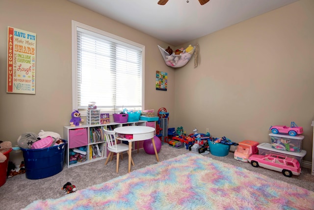 rec room with ceiling fan and carpet floors