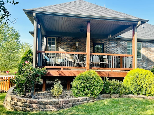 rear view of property featuring a wooden deck