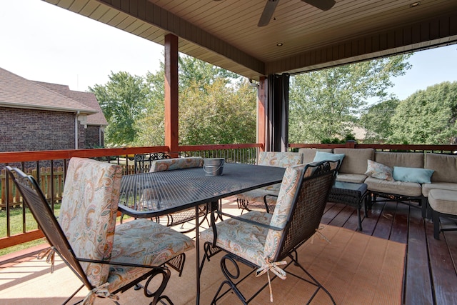 wooden deck with an outdoor hangout area and ceiling fan