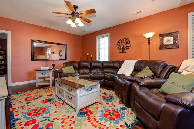 living room featuring wood-type flooring and ceiling fan