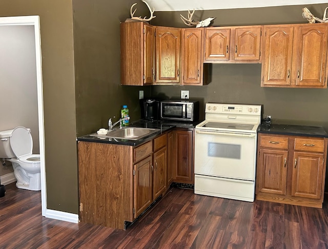 kitchen featuring white electric range, sink, and dark wood-type flooring