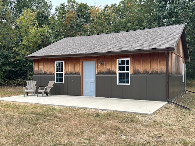 view of outbuilding featuring a lawn