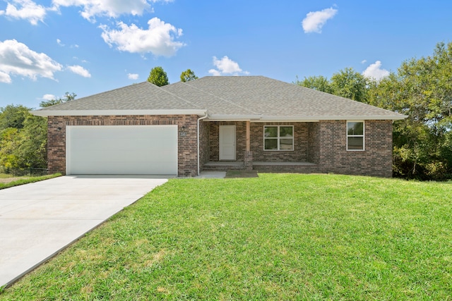 single story home with a garage and a front lawn