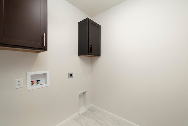 clothes washing area with hookup for a washing machine, cabinets, and hookup for an electric dryer