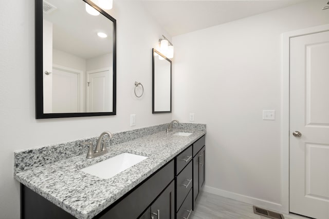 bathroom with hardwood / wood-style floors and vanity