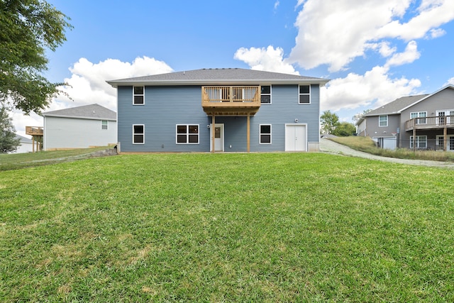 back of house with a yard and a balcony