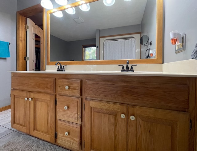 bathroom with vanity and tile patterned floors