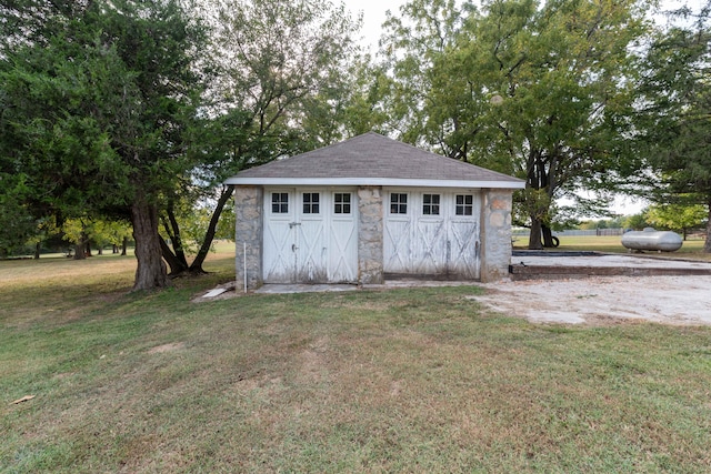 view of outbuilding featuring a yard and a garage