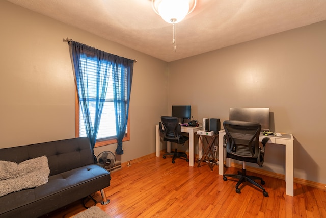 home office featuring a textured ceiling and light wood-type flooring