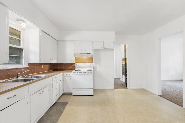 kitchen with electric stove, backsplash, sink, and white cabinetry