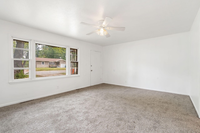 spare room with ceiling fan and carpet flooring