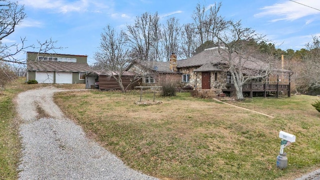 view of front of home with an outbuilding, a deck, and a front yard