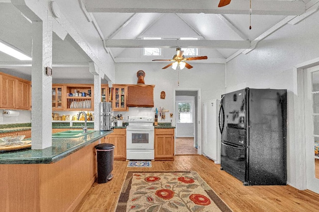 kitchen featuring electric range, sink, black fridge, high vaulted ceiling, and light hardwood / wood-style floors