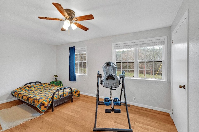 bedroom with ceiling fan and wood-type flooring