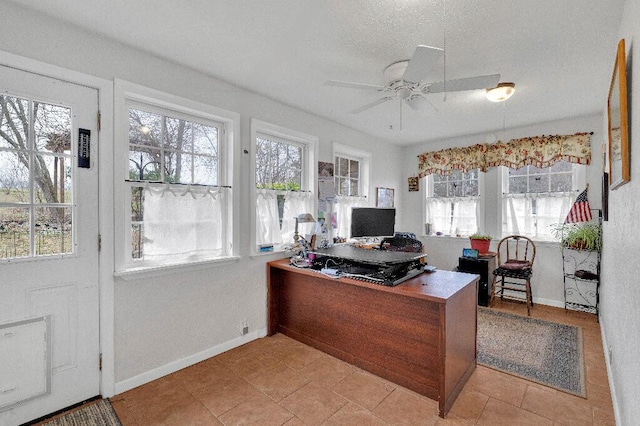 tiled home office featuring ceiling fan and a textured ceiling